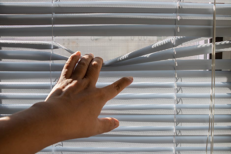 Professional contractor measuring and installing custom window blinds